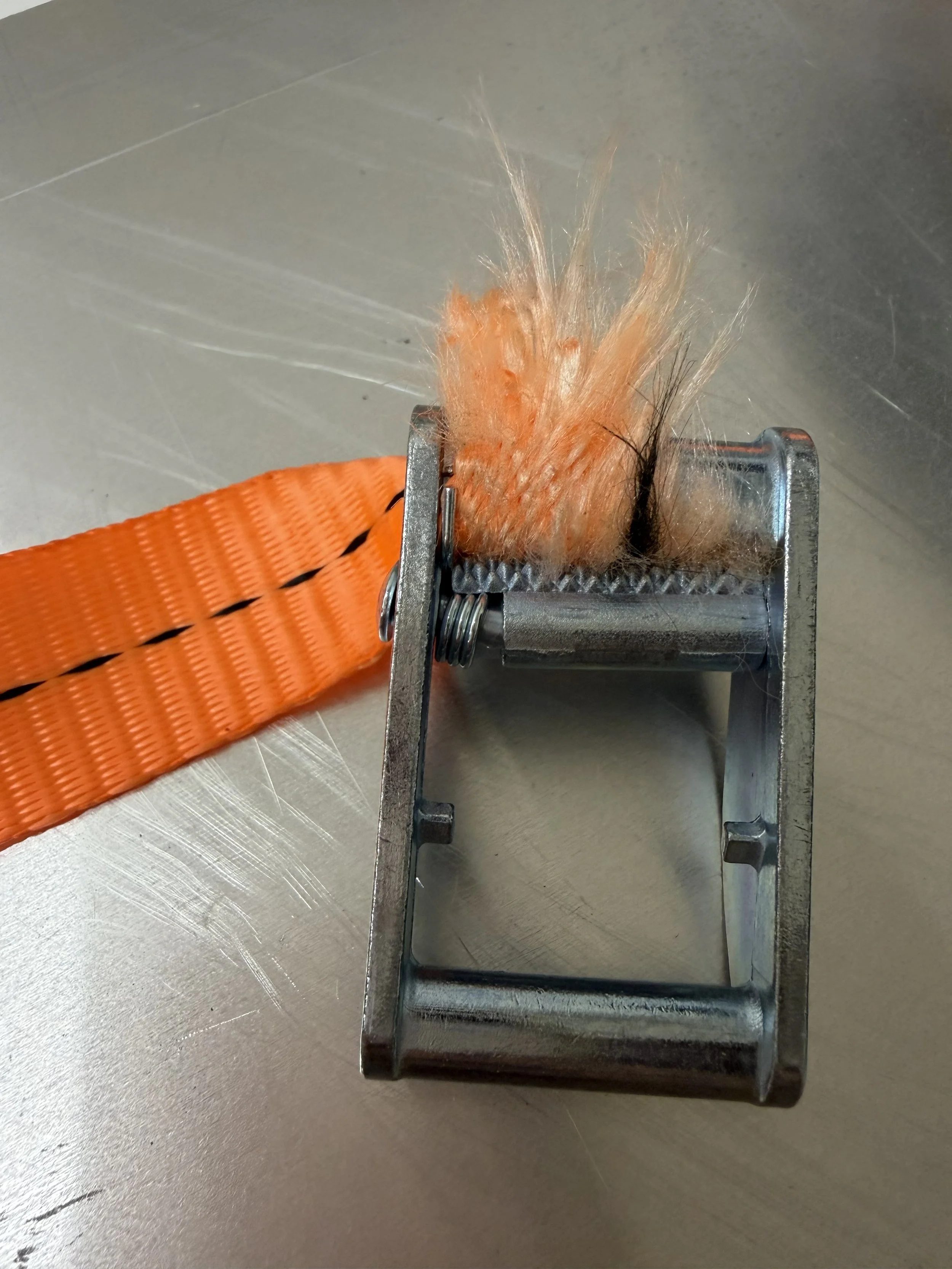 Webbing failure at hardware interface following tensile testing