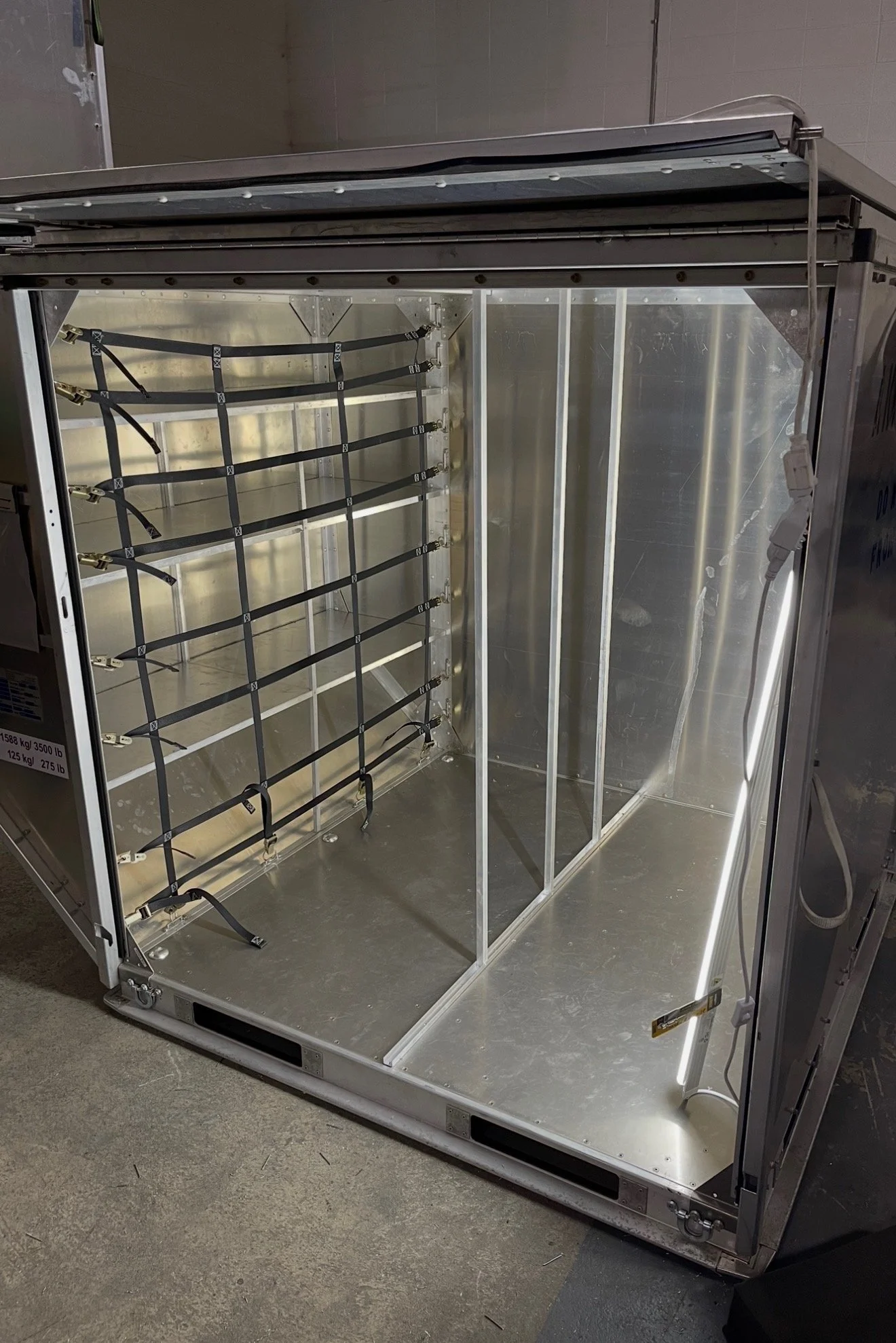 Cargo container interior after alteration to add shelving and subdivide the interior
