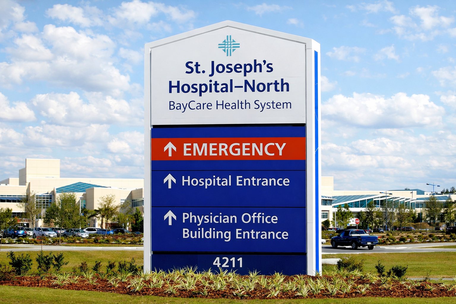 Hospital sign indicating emergency, hospital entrance, and physician office building entrance at St. Joseph's Hospital North, part of BayCare Health System.