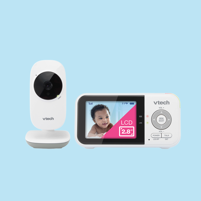 Baby monitor with a camera on the left and a screen displaying a smiling baby on the right, with a pink label indicating a 2.8-inch LCD screen.