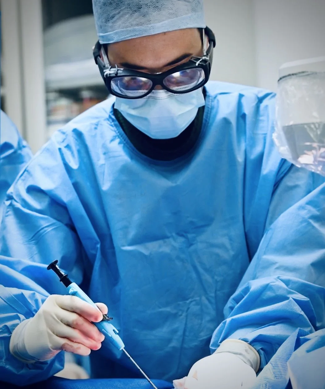 Dr Christopher Cook, Consultant Cardiologist, performing a minimally invasive TAVI (Transcatheter Aortic Valve Implantation) procedure in a cardiac catheterisation lab