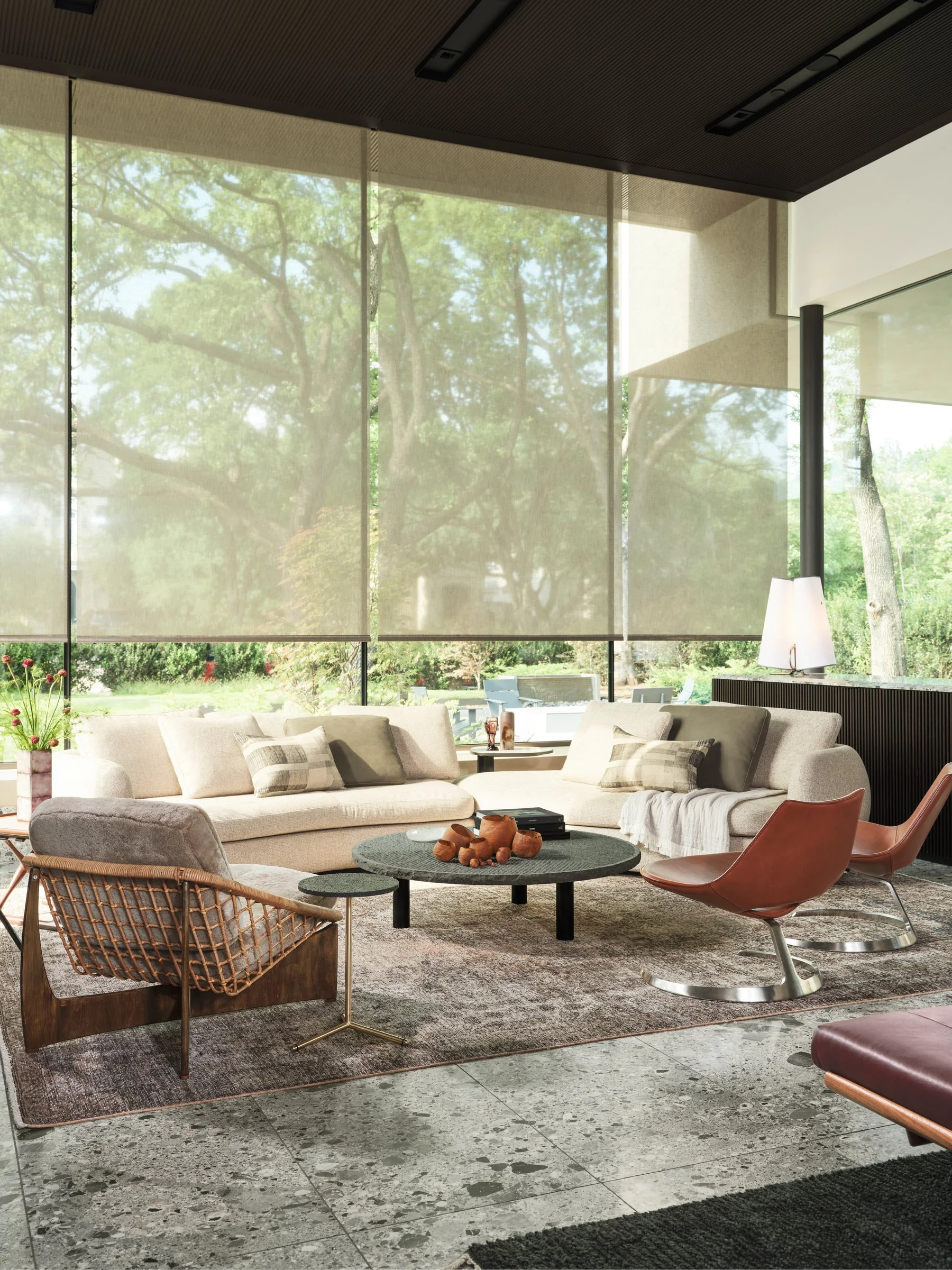 Living area with layered seating, terrazzo flooring, and filtered natural light, balancing softness with architectural structure. Vintage Leather ‘Scimitar’ chairs by Fabricius – Kastholm, Vintage “Rokato” Lounge Chair by Gebroeders Jonkers Noordwold