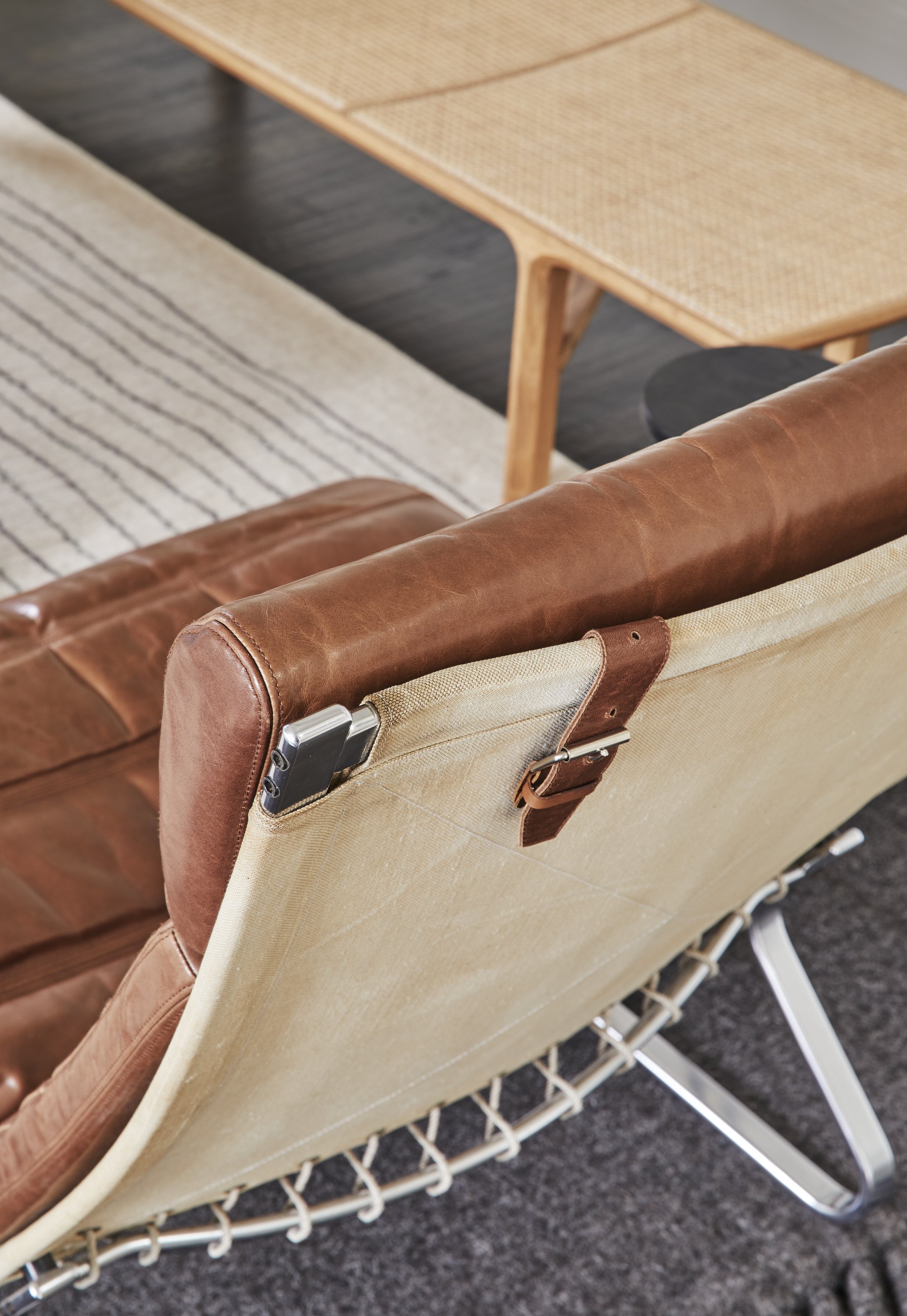 Leather and canvas lounge chair with metal frame detail in modern luxury interior seating area fabricius kastholm