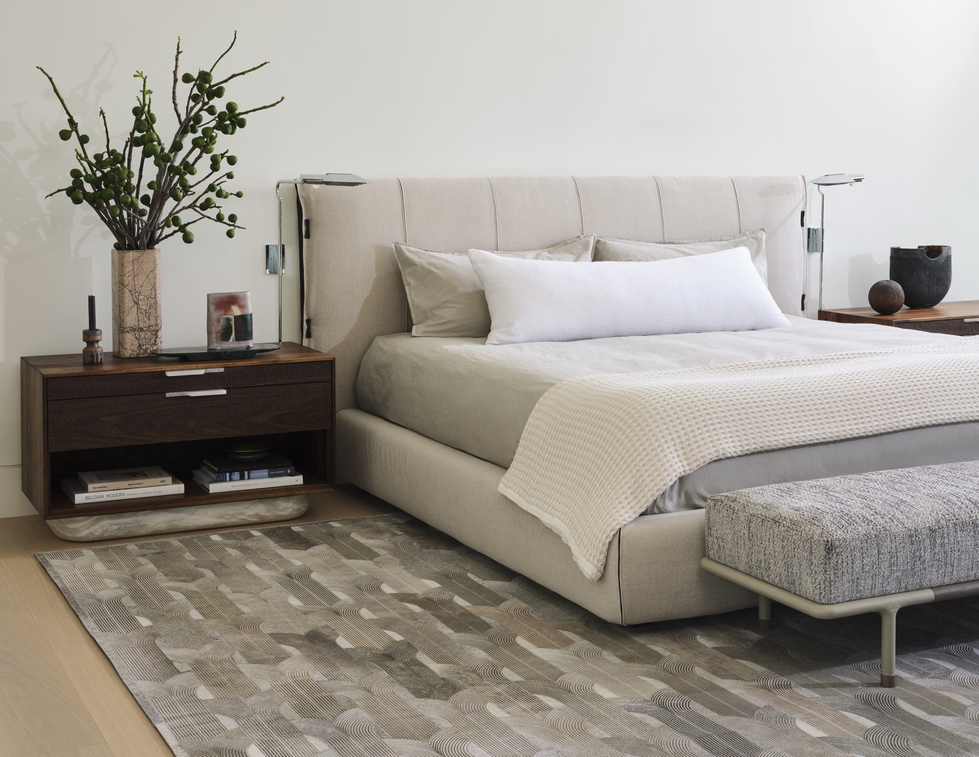 Modern luxury bedroom with upholstered platform bed, walnut nightstands, and minimalist bedside lighting. cedric hartman lamps, swell studio + joshua rice custom bedside tables