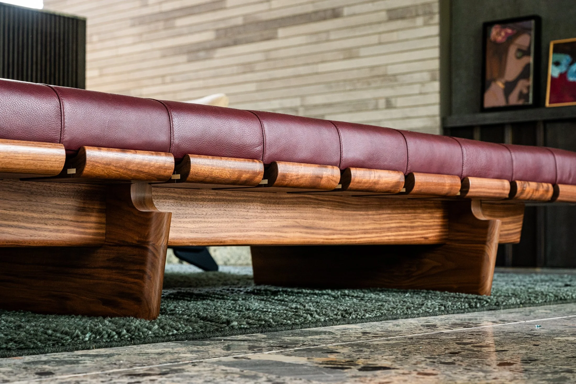 Custom Oxblood Leather and Walnut “BLR” daybed designed by Joshua Rice, showcasing craftsmanship and material depth in a modern interior.