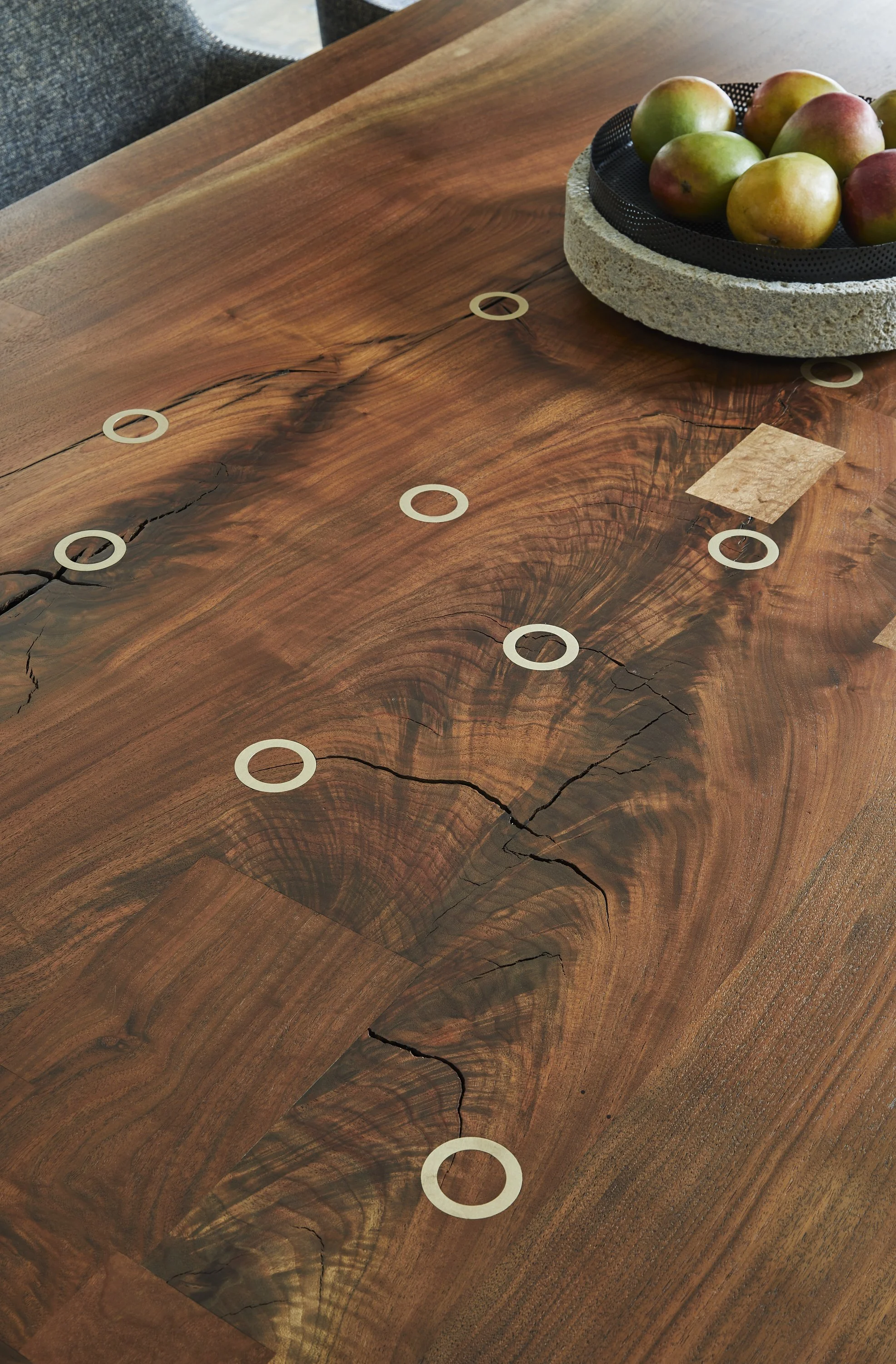 Custom walnut dining table with brass inlay detailing and natural wood grain in luxury interior design jeff martin joinery