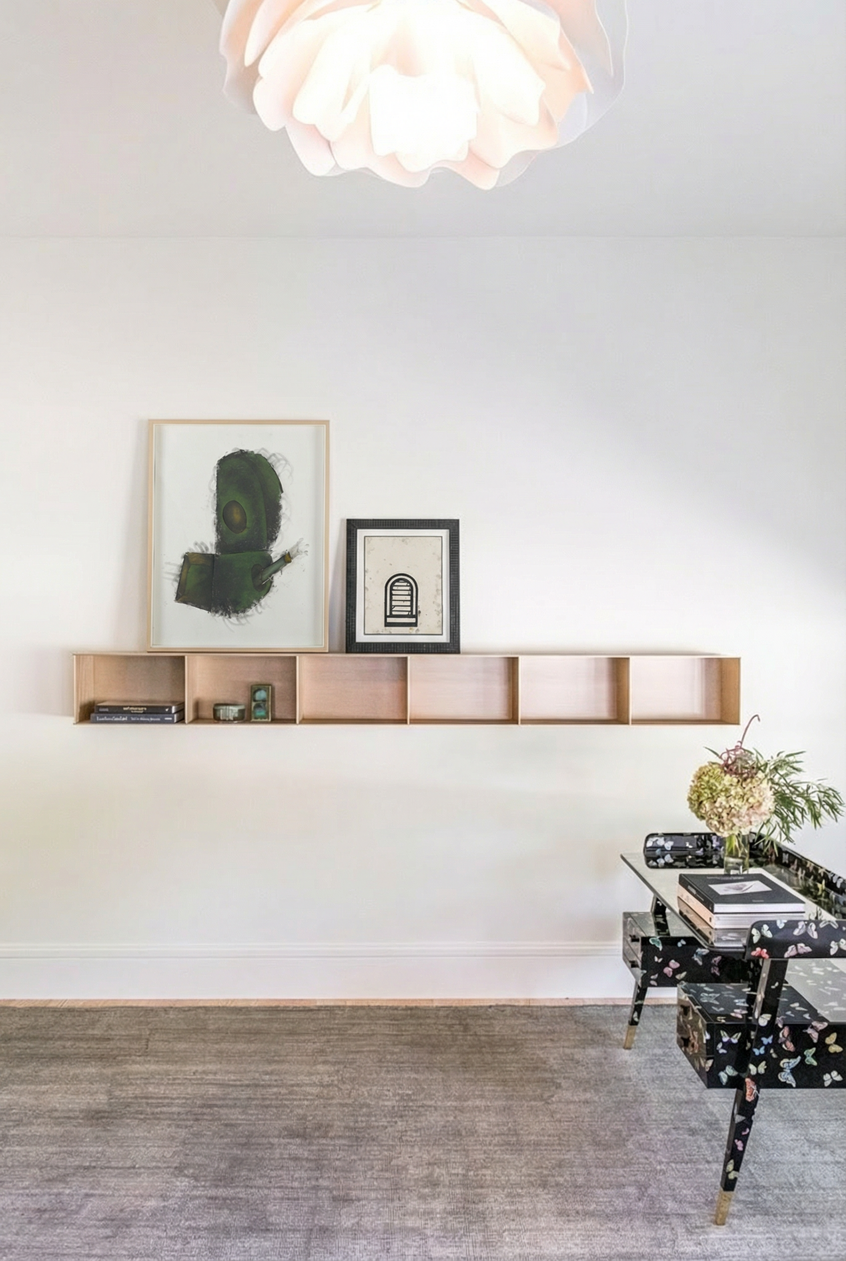 Minimal study with floating aluminum shelf, by Jonathan Nesci, curated contemporary artwork, and lacquered butterfly desk by Gio Ponti in a calm, collected luxury home interior.