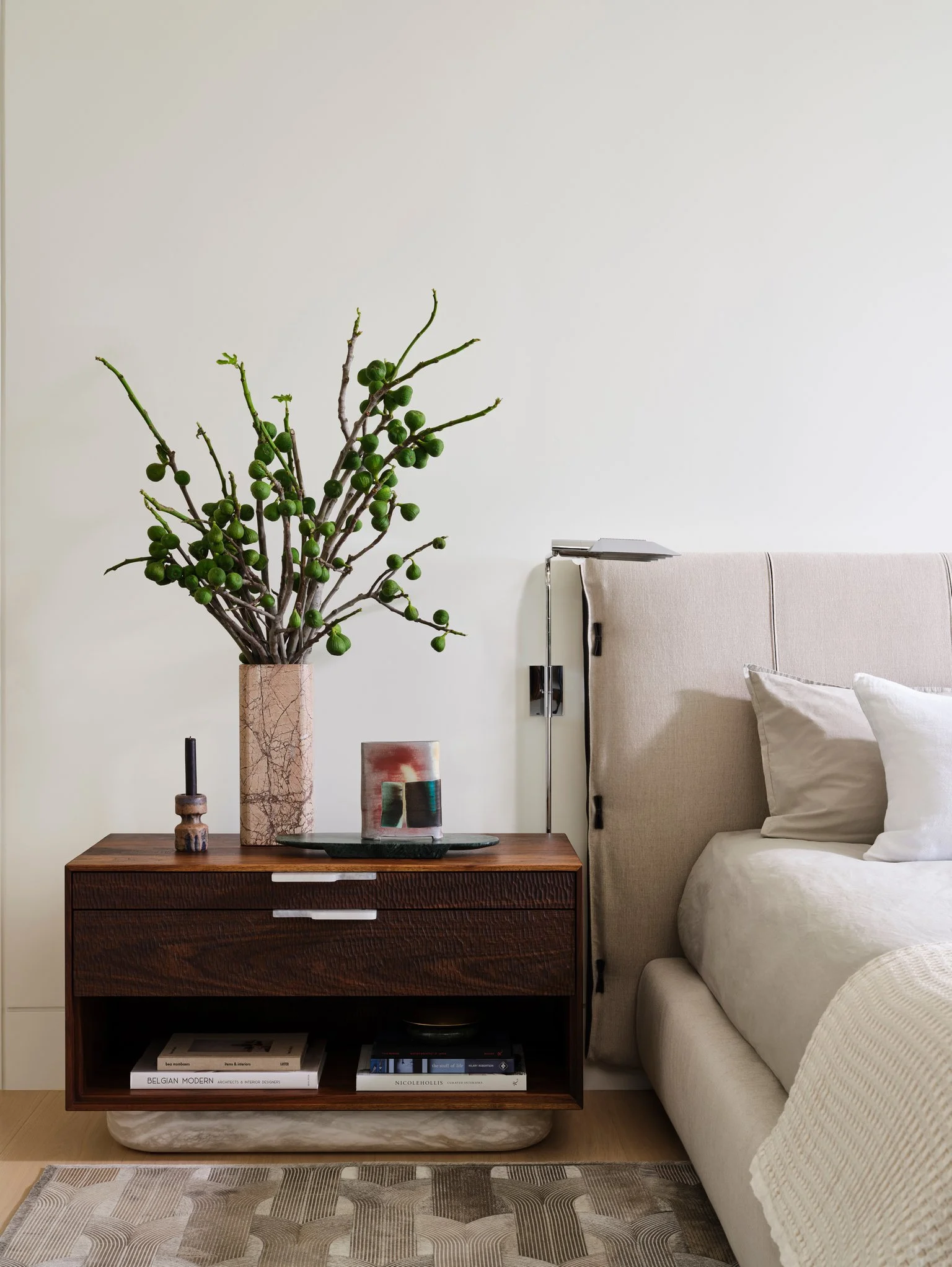 Modern luxury bedroom with upholstered platform bed, walnut nightstands, and minimalist bedside lighting. cedric hartman lamps, swell studio + joshua rice custom bedside tables