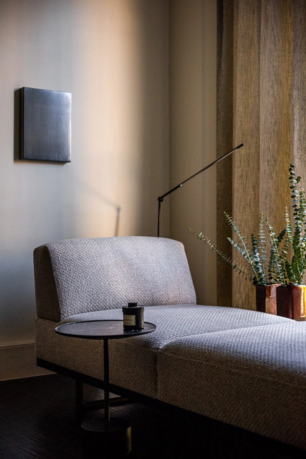 Minimal modern lounge seating vignette with upholstered chaise, sculptural lighting, and contemporary art Matthew Allen