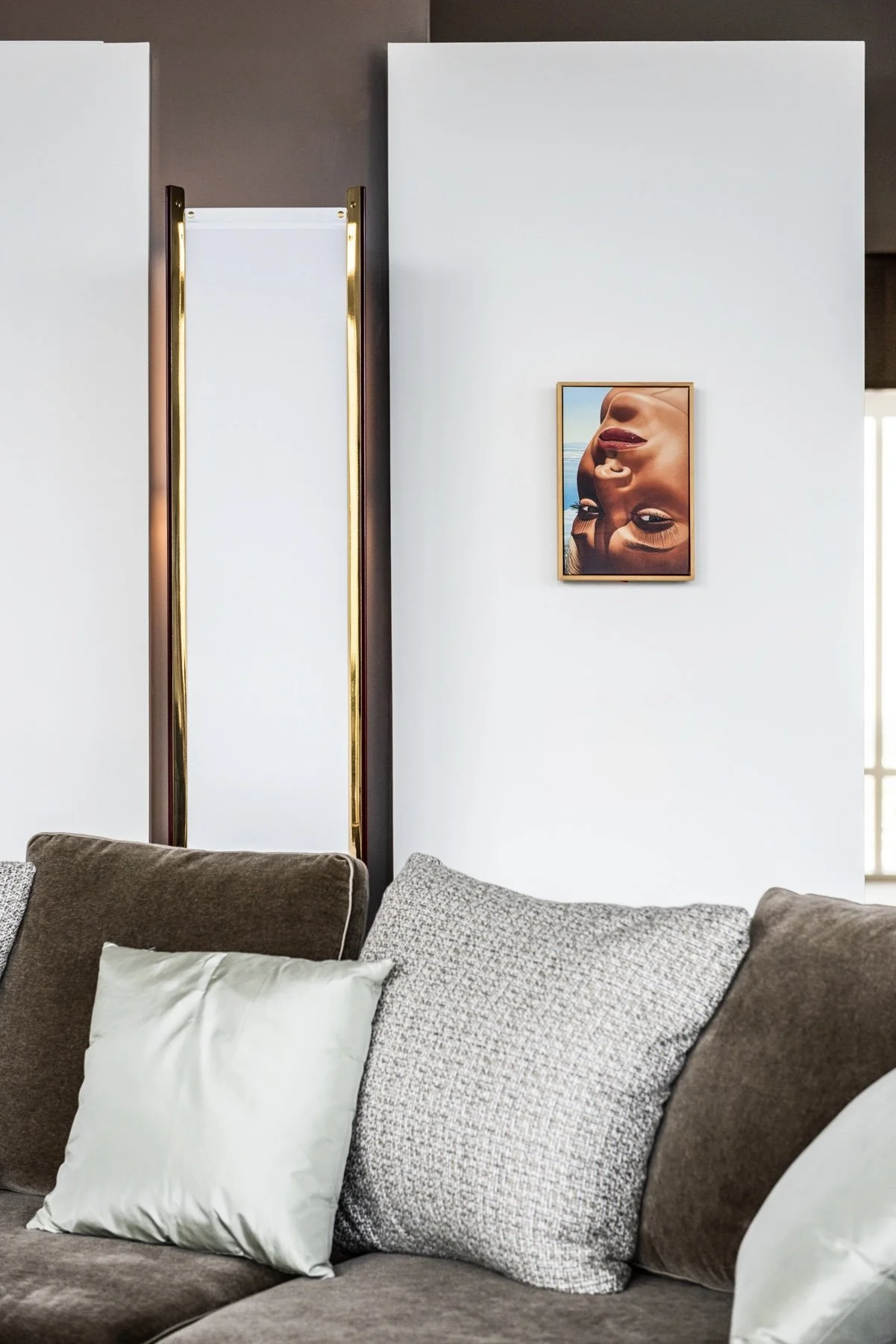 Luxury modern living room sofa vignette with sculptural wall lighting and contemporary portrait artwork. azucena Luigi Caccia Dominioni, Ignazio Gardella pop art