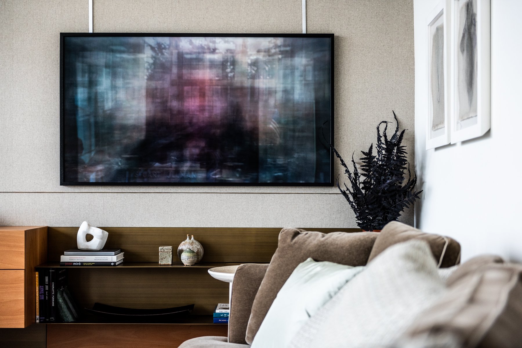 Modern living room with large abstract artwork, wood console, and sculptural decorative objects Bruce Silverstein Photography, the shining porro