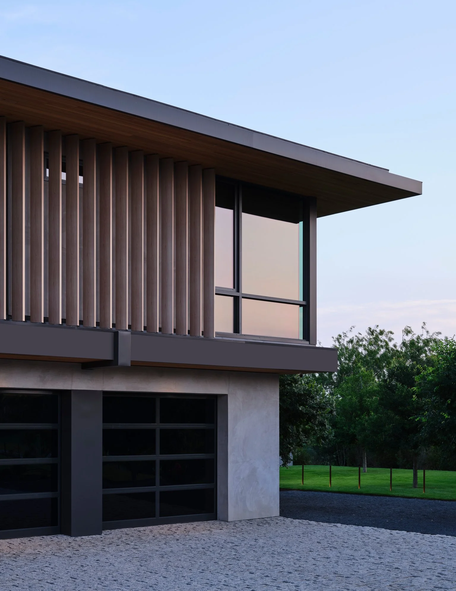 Evening View of multicar luxury garage for a collector with exterior view of chef kitchen above