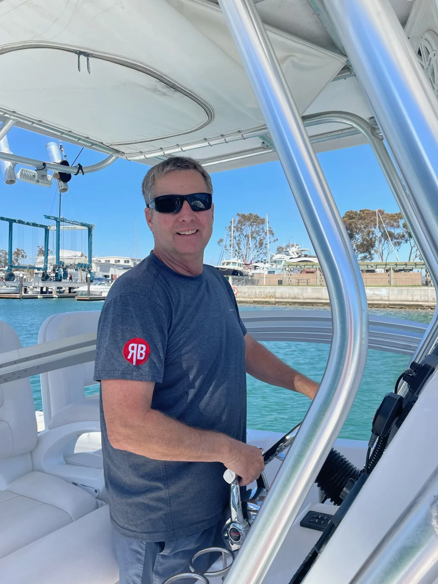 Robert Brown driving his boat in a harbor.