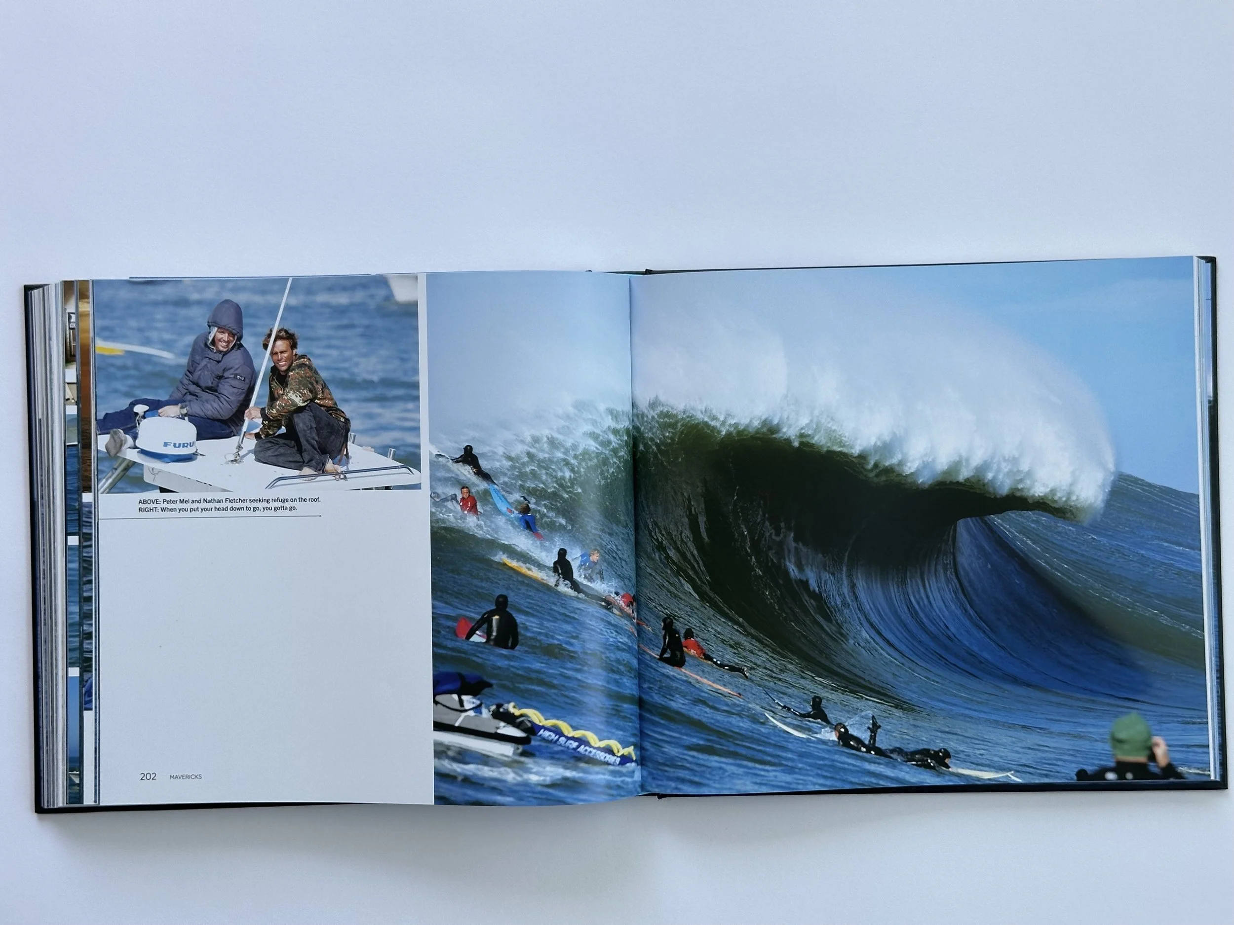 Pages within Pacific Quests book. Features surfers on a large wave.