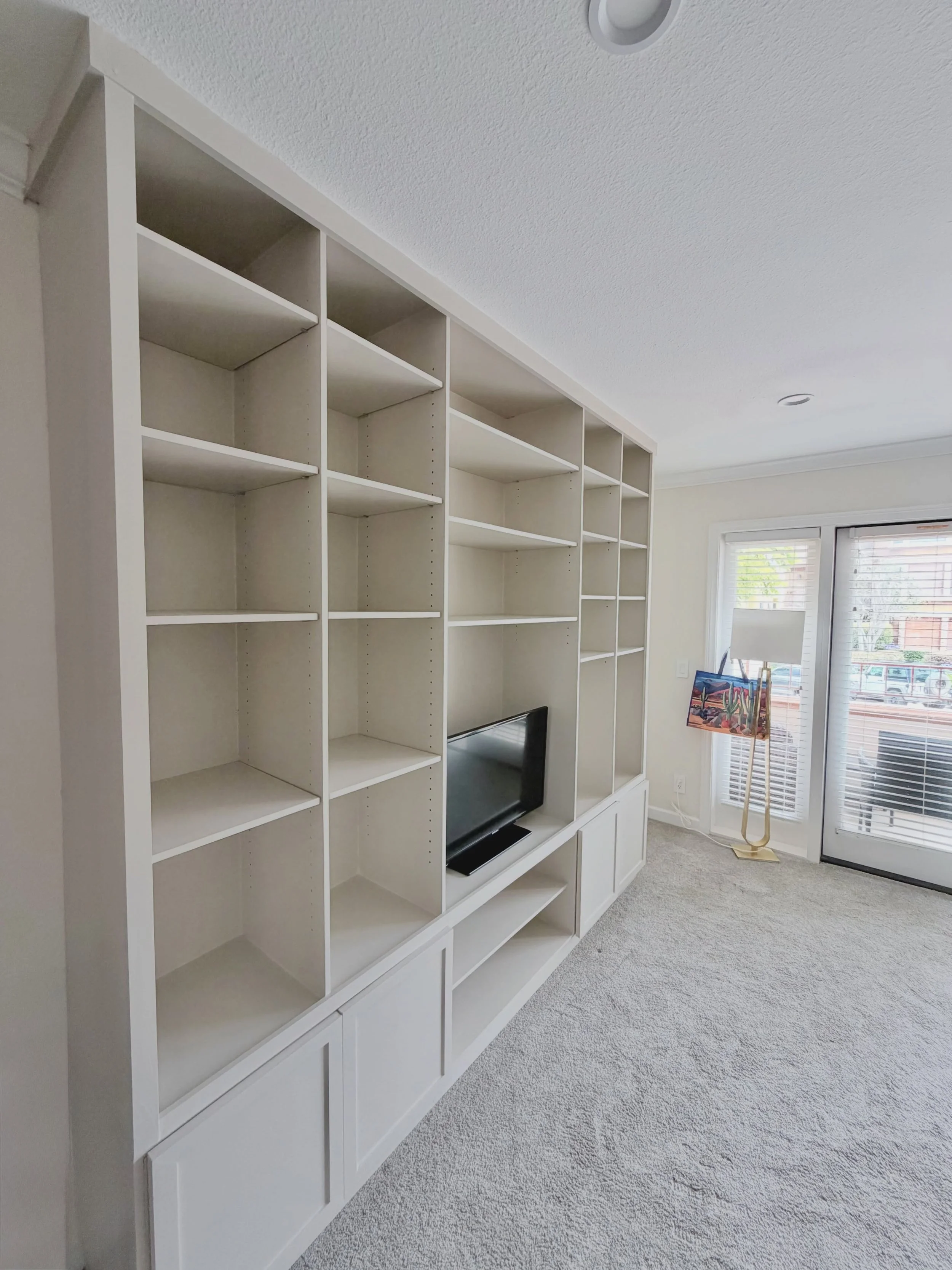 Before &rarr; After

Custom built-in bookcase completed in La Jolla.

We transformed this TV wall into a cleaner, more functional built-in with open shelving, lower cabinet storage, and a centered entertainment area.

Built by SAND | Builders
San Die