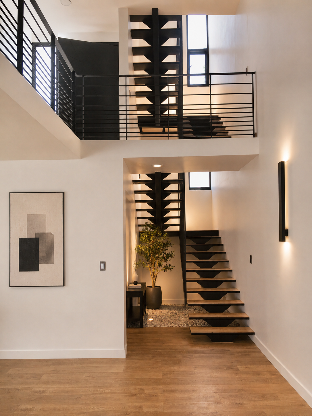 Custom floating staircase with black steel and wood treads in a modern San Diego home by SAND Builders