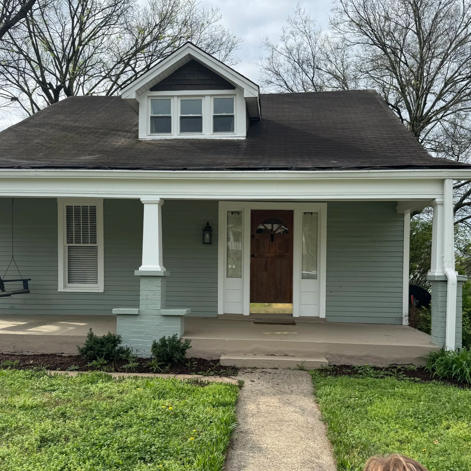 Home exterior before refresh, showing entry and landscaping prior to coordinated project planning