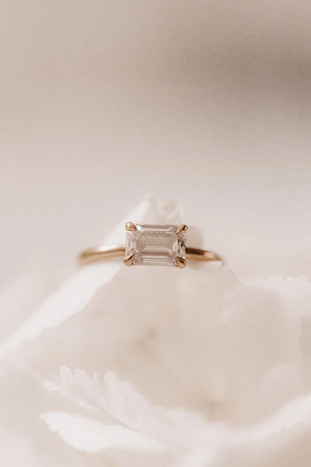 Verlobung mit einem rechteckigen Diamanten auf einer weißen Blume