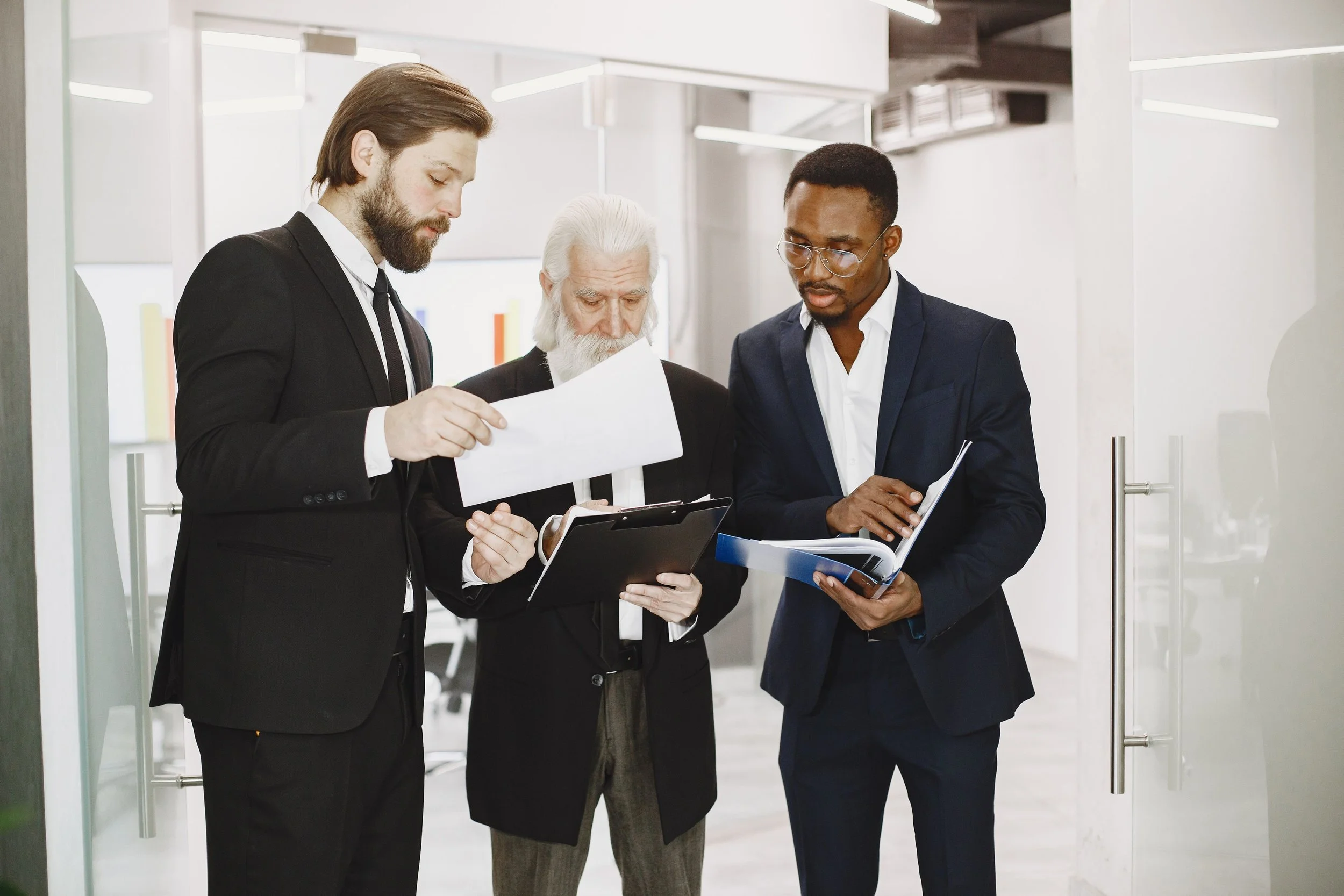 Diverse group of men reviewing financials