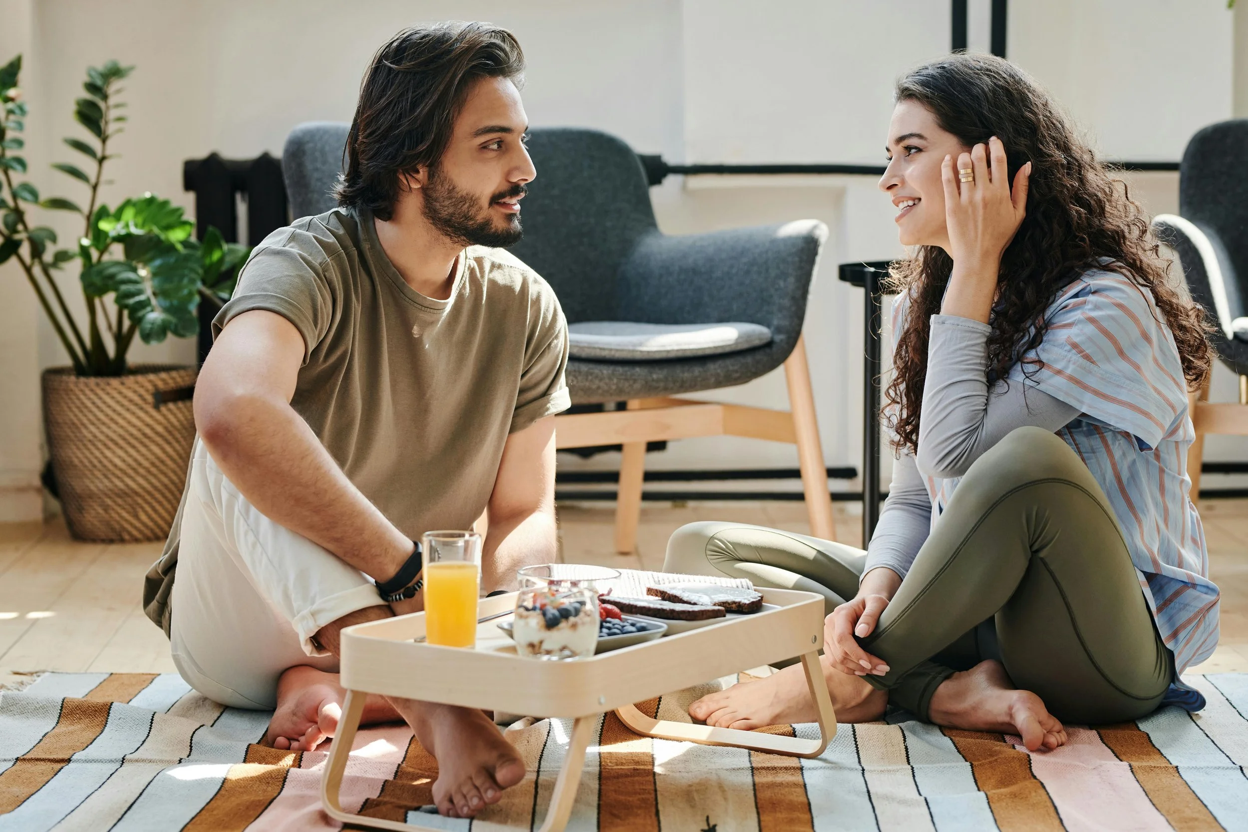 Two people sharing a relaxed meal at home, the kind of easier relationship with food this work moves toward.
