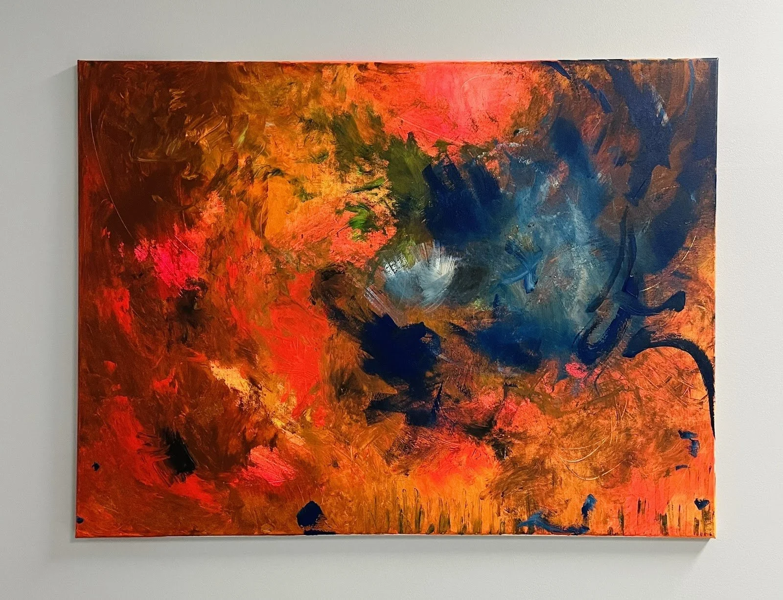 Abstract painting with bold strokes of orange, red, blue, green, black, and white on canvas.