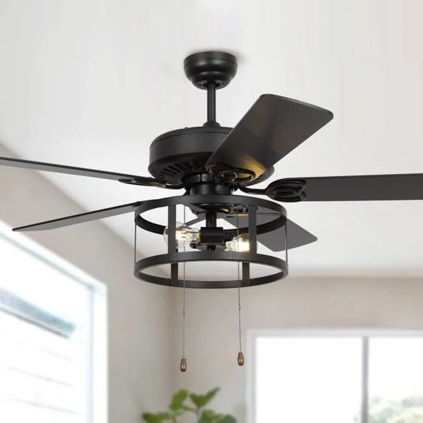 Black ceiling fan with built-in light fixture in a room with white walls and large windows.
