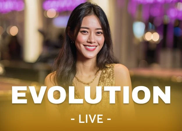 A smiling woman in a gold dress at a lively event, with the words "EVOLUTION LIVE" displayed in front.