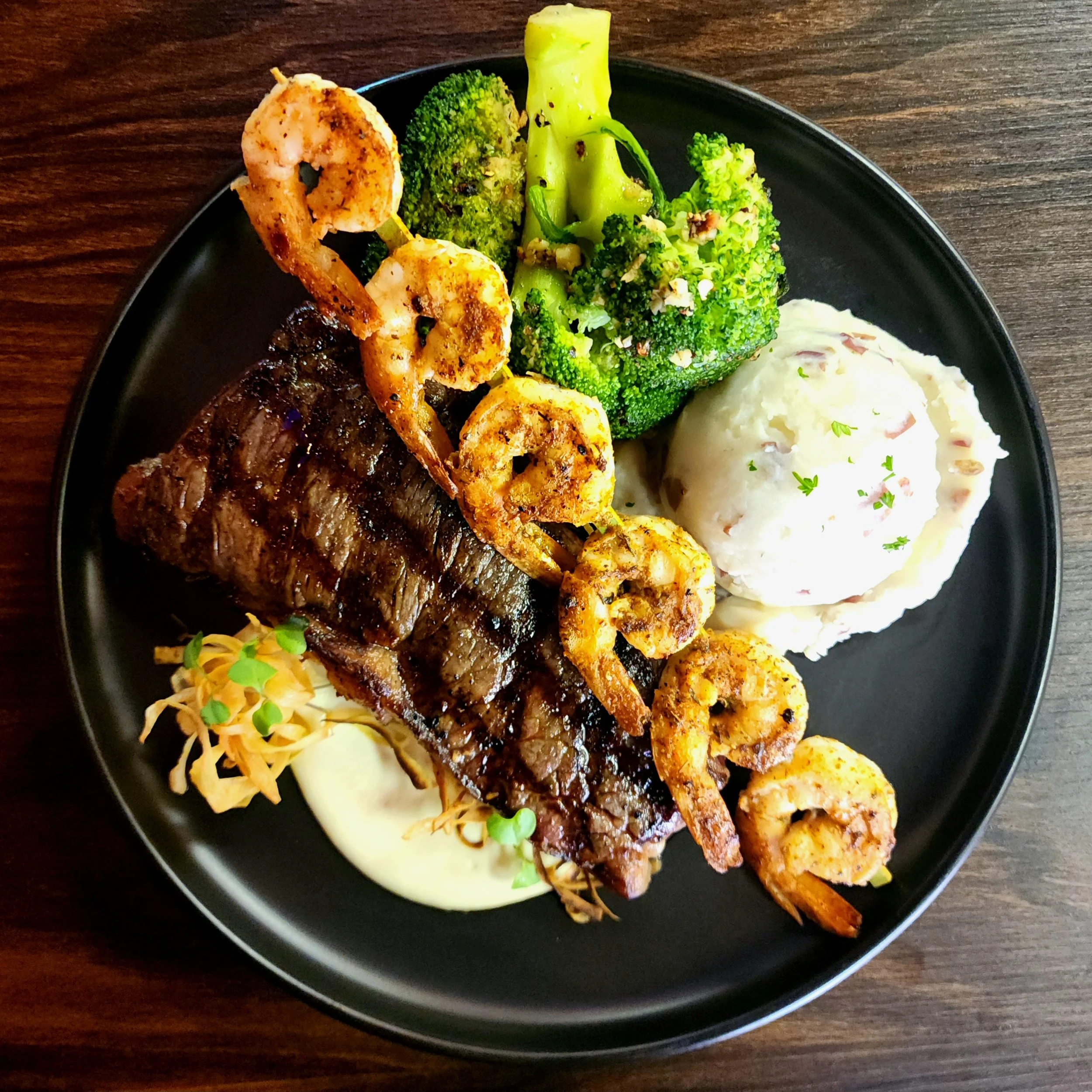 Naomi's 12oz USDA Prime NY Strip with Blackened Gulf Shrimp & Two Sides.
