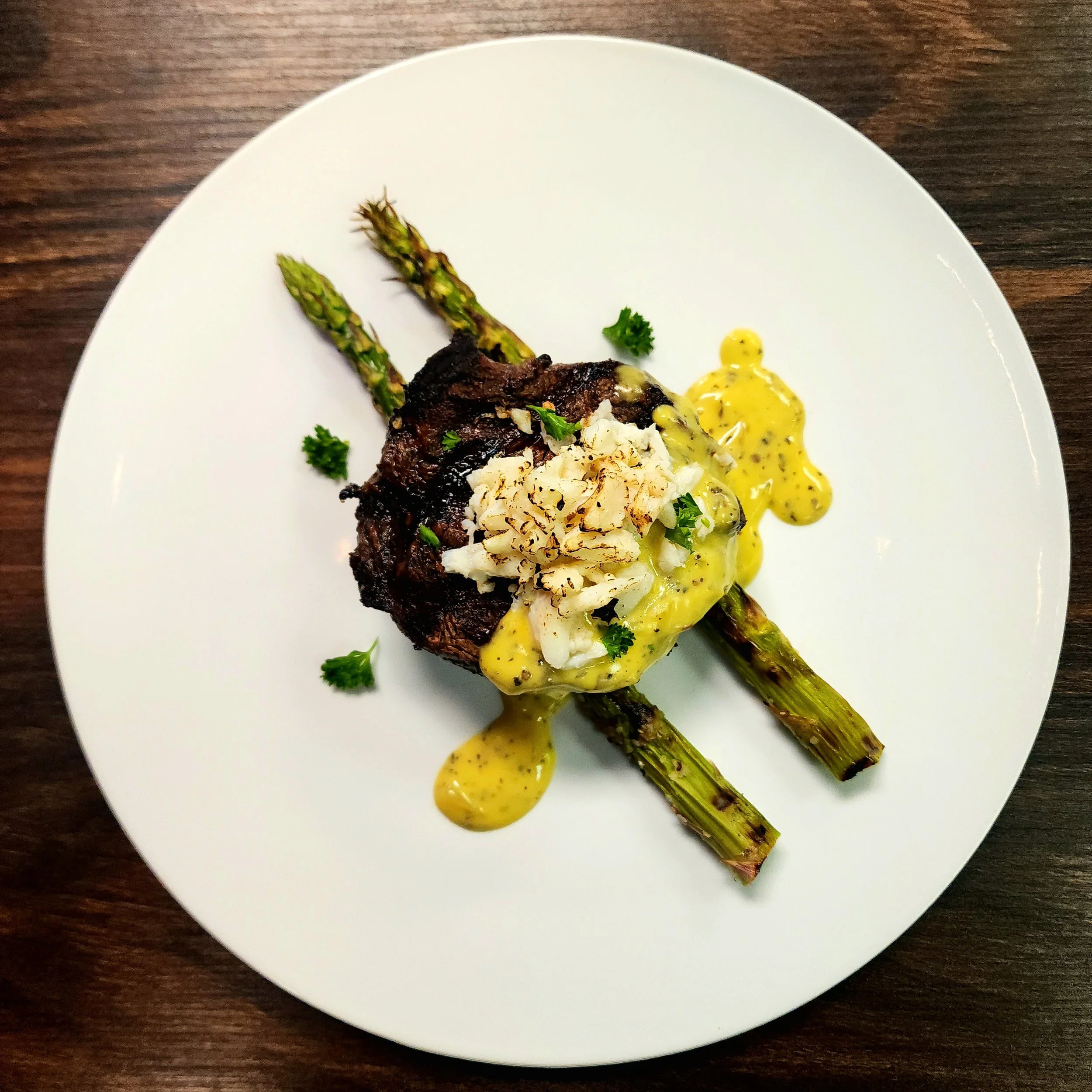 Rib Cap Oscar - House Butchered Rib Cap, Jumbo Lump Crab, Bearnaise, & Grilled Jumbo Asparagus. 