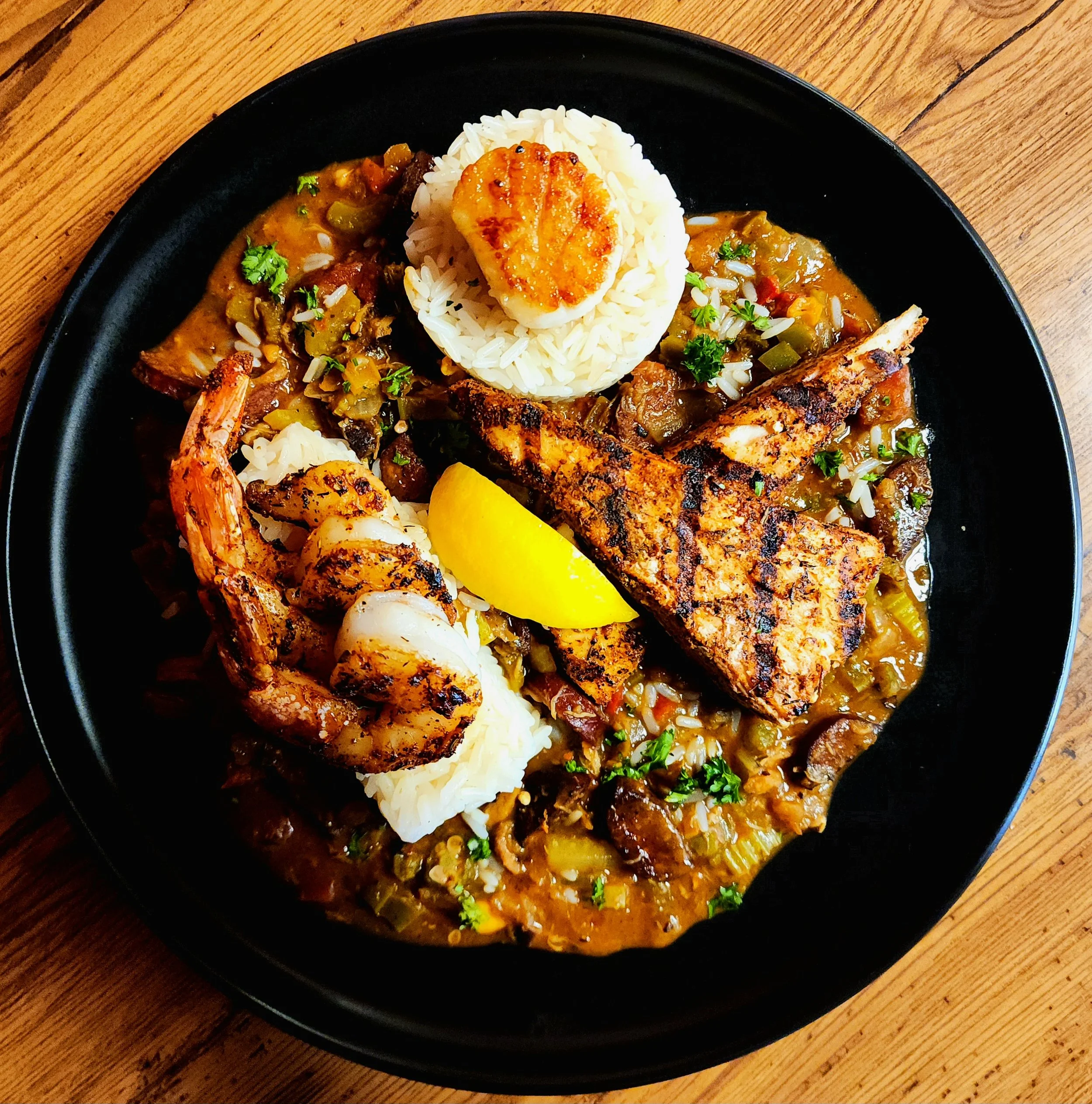 Loaded Seafood Gumbo with Blackened Gulf Shrimp, Red Snapper, & Pan Seared Sea Scallops. 