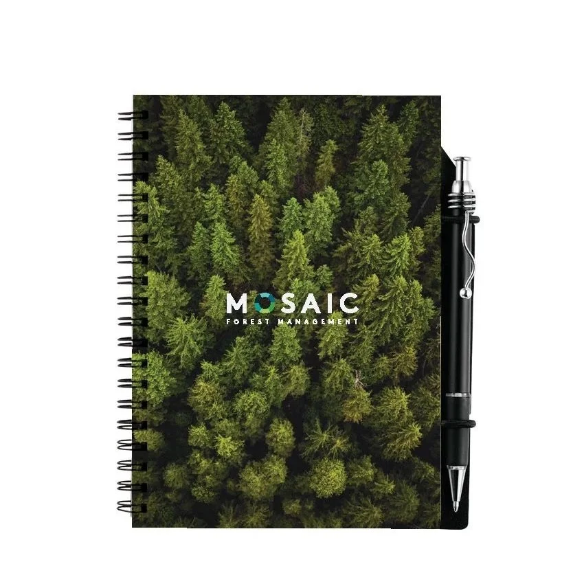 Spiral notebook with a cover photo of a dense green forest and a black pen attached to the right side, labeled 'MOSAIC Forest Management'.