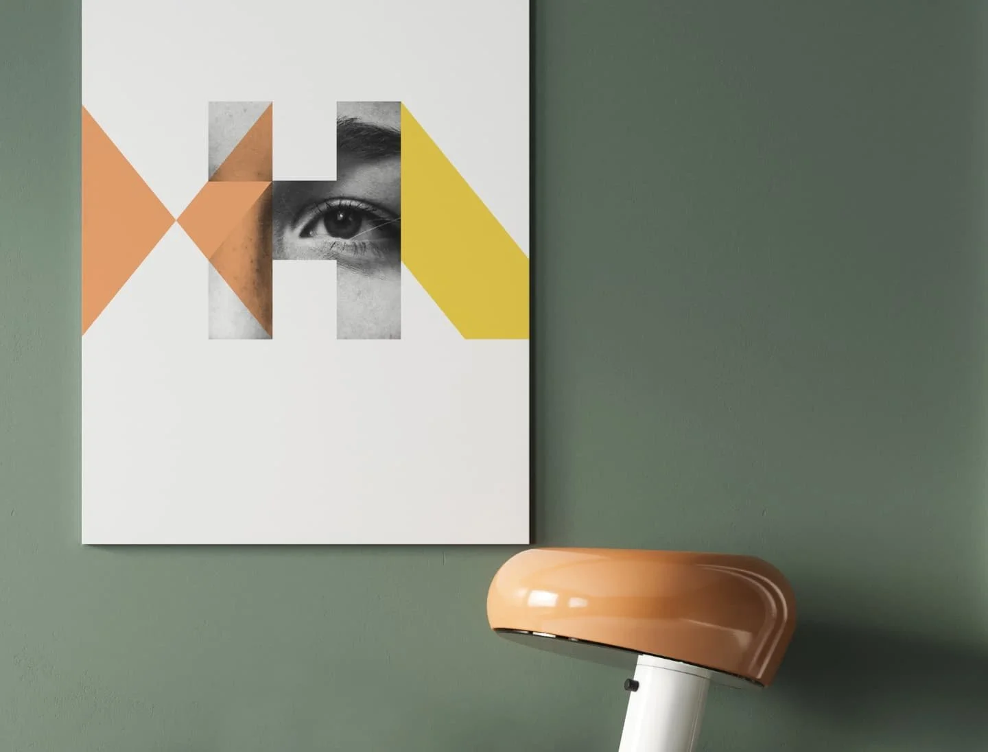 Art print of a black and white eye with geometric colored shapes on a green wall, next to a beige and white lamp.