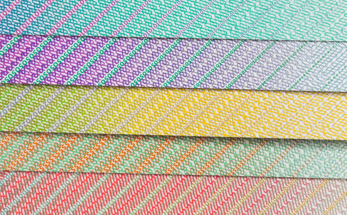 Colorful patterned paper strips with various diagonal line designs in shades of blue, purple, yellow, orange, green, and red.