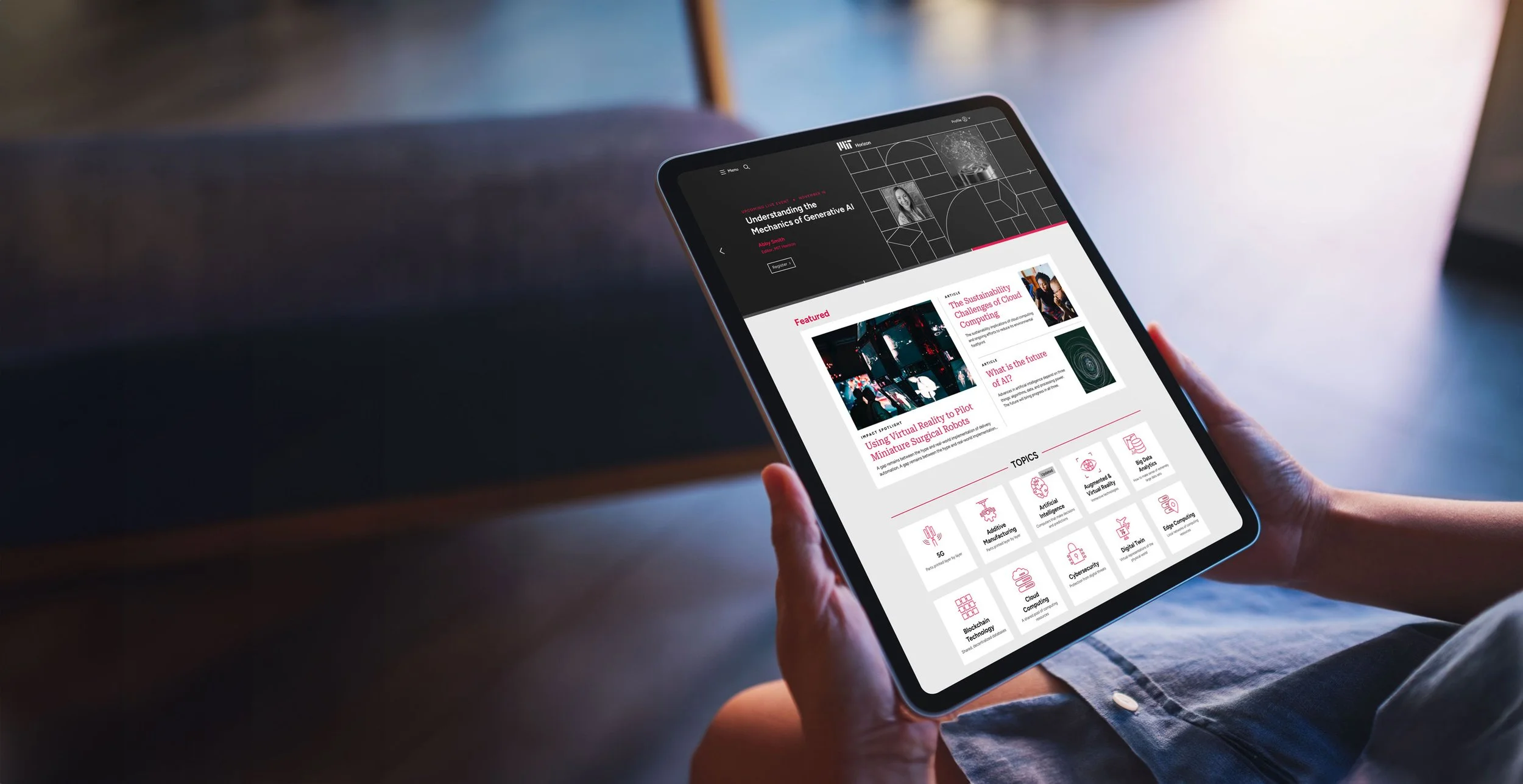 Person holding a tablet displaying a website with articles and topics related to artificial intelligence, robotics, cloud computing, and cybersecurity, on a wooden table.