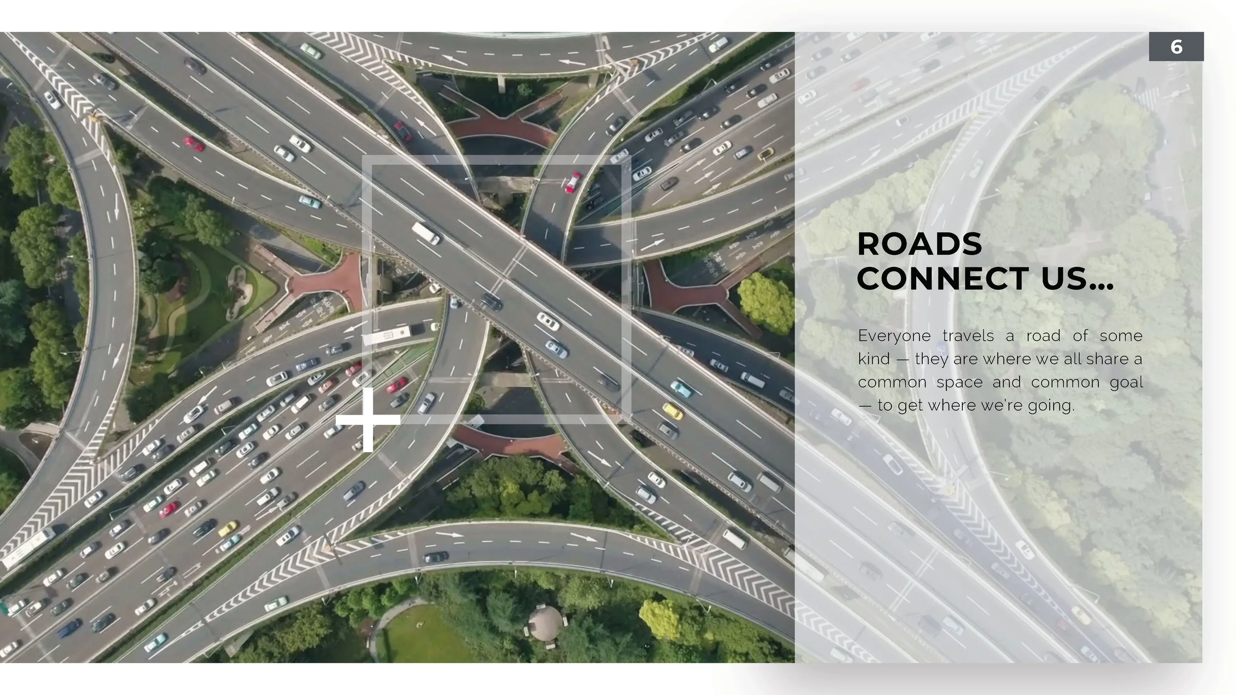 An aerial view of a complex highway interchange with multiple roads and overpasses surrounded by green trees and parks.