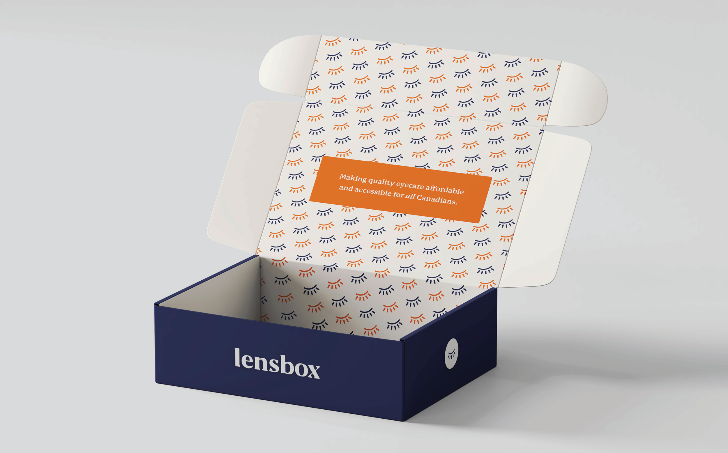 Open box with branded packaging for Lensbox, containing eye care product information and slogan on printed paper inside.
