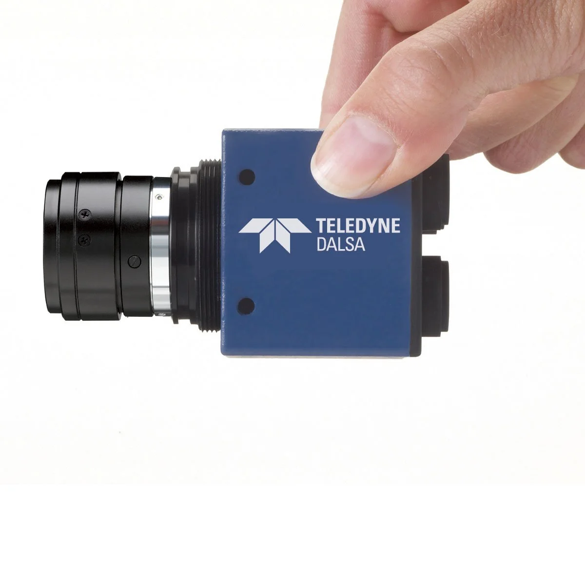 A person's hand holding a blue industrial camera with the logo and text "TELEDYNE DALSA" on it, against a white background.