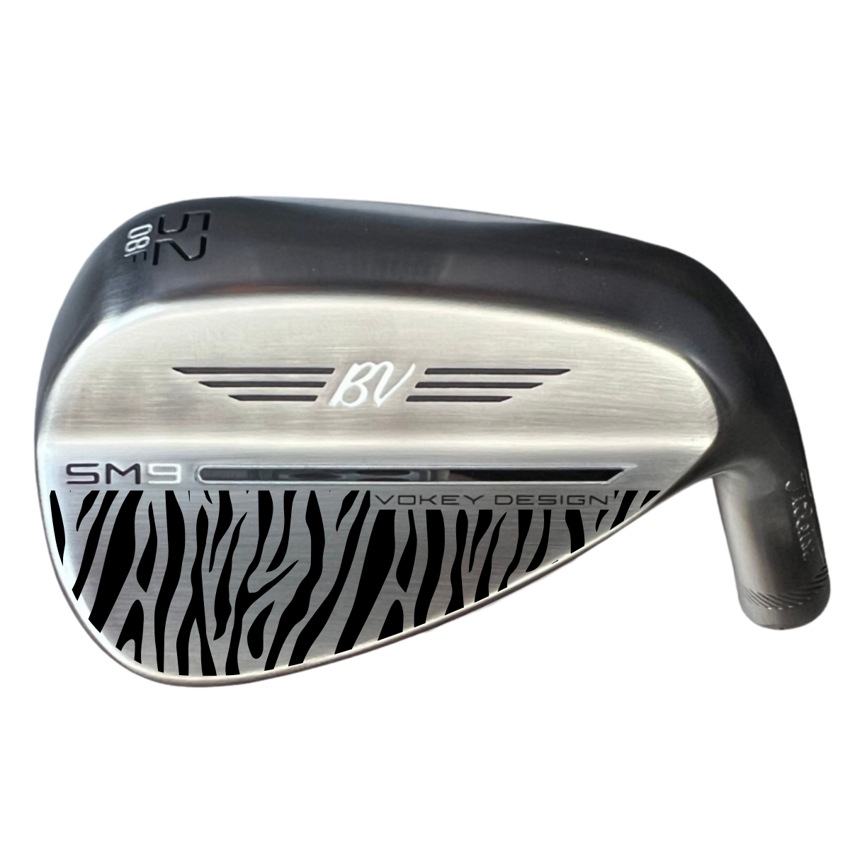 A golf club with a black and silver head, featuring zebra stripe patterns on the bottom and branding including 'BV,' 'SM 9,' and 'Vokey Design'.