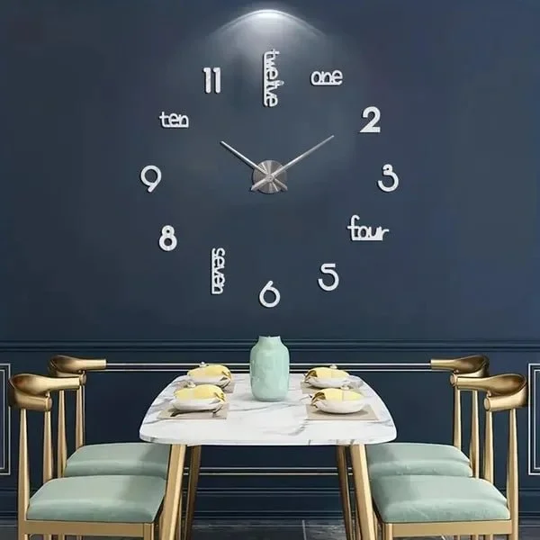A modern dining room with a large wall clock featuring numbers written as words and Roman numerals, and a white marble dining table with four gold-accented chairs and a large light-colored vase in the center.