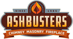 Ash Busters logo featuring a flame icon, with text indicating chimney, masonry, and fireplace services since 1985.