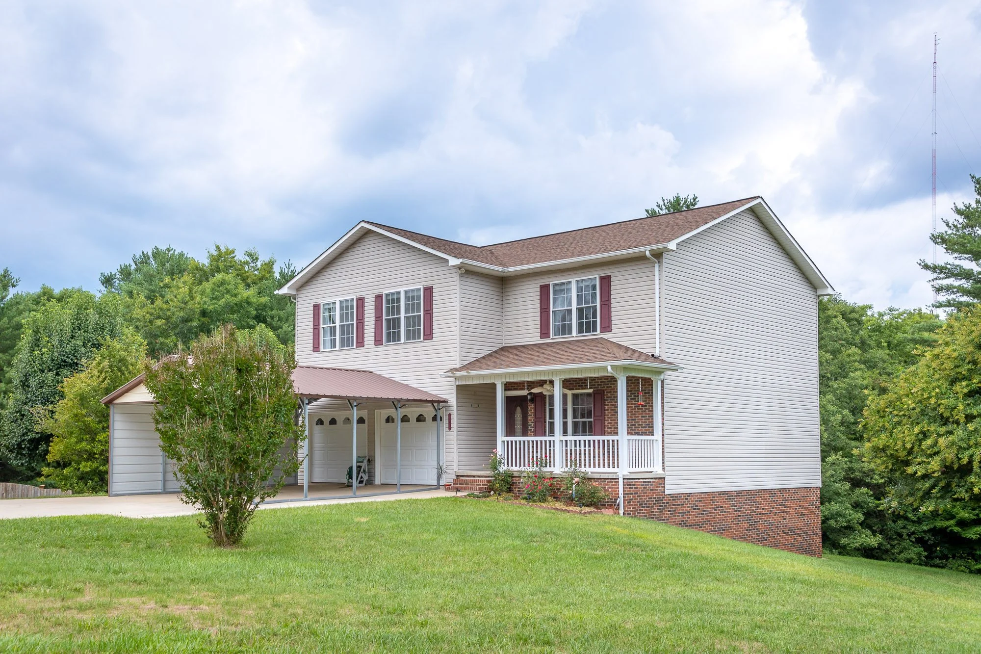 Two-story house with beige siding. Large enough for a family to settle down and make it a long term residence and a great rental.