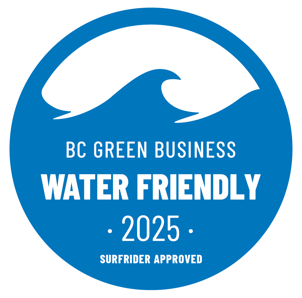 Circular blue badge with black wave graphic and white text reading "BC Green Business Water Friendly 2025 Surfrider Approved."