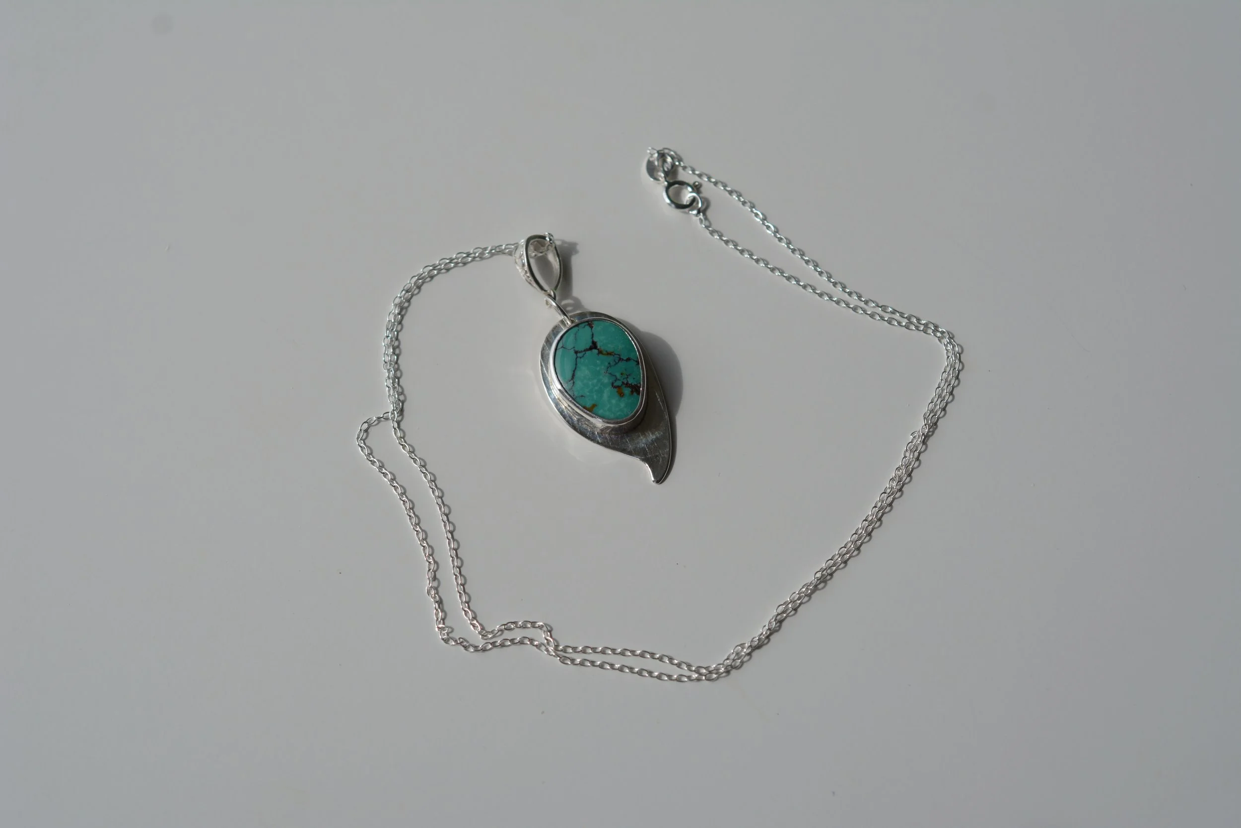 Cloud Mountain Turquoise Silver necklace set on a pale background