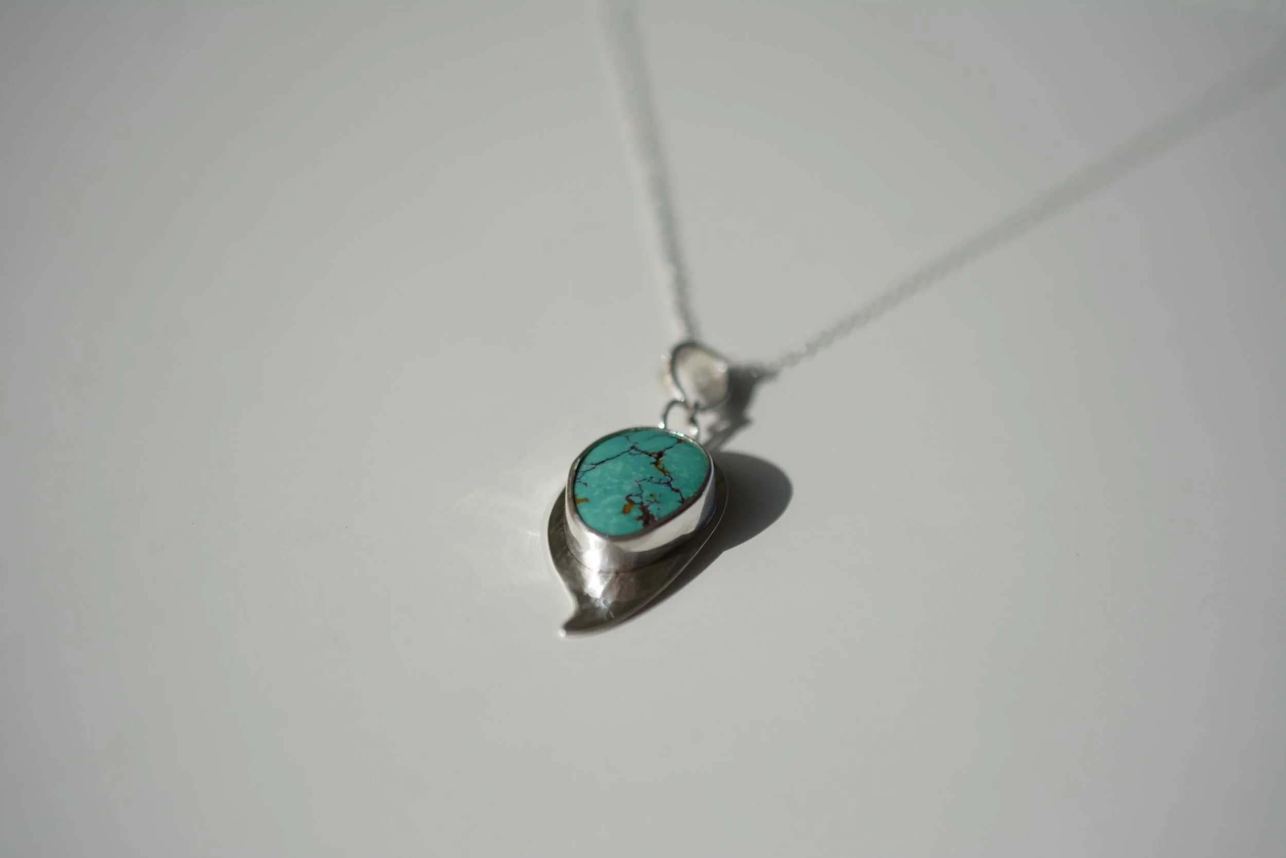 Cloud Mountain Turquoise Silver necklace set on a pale background