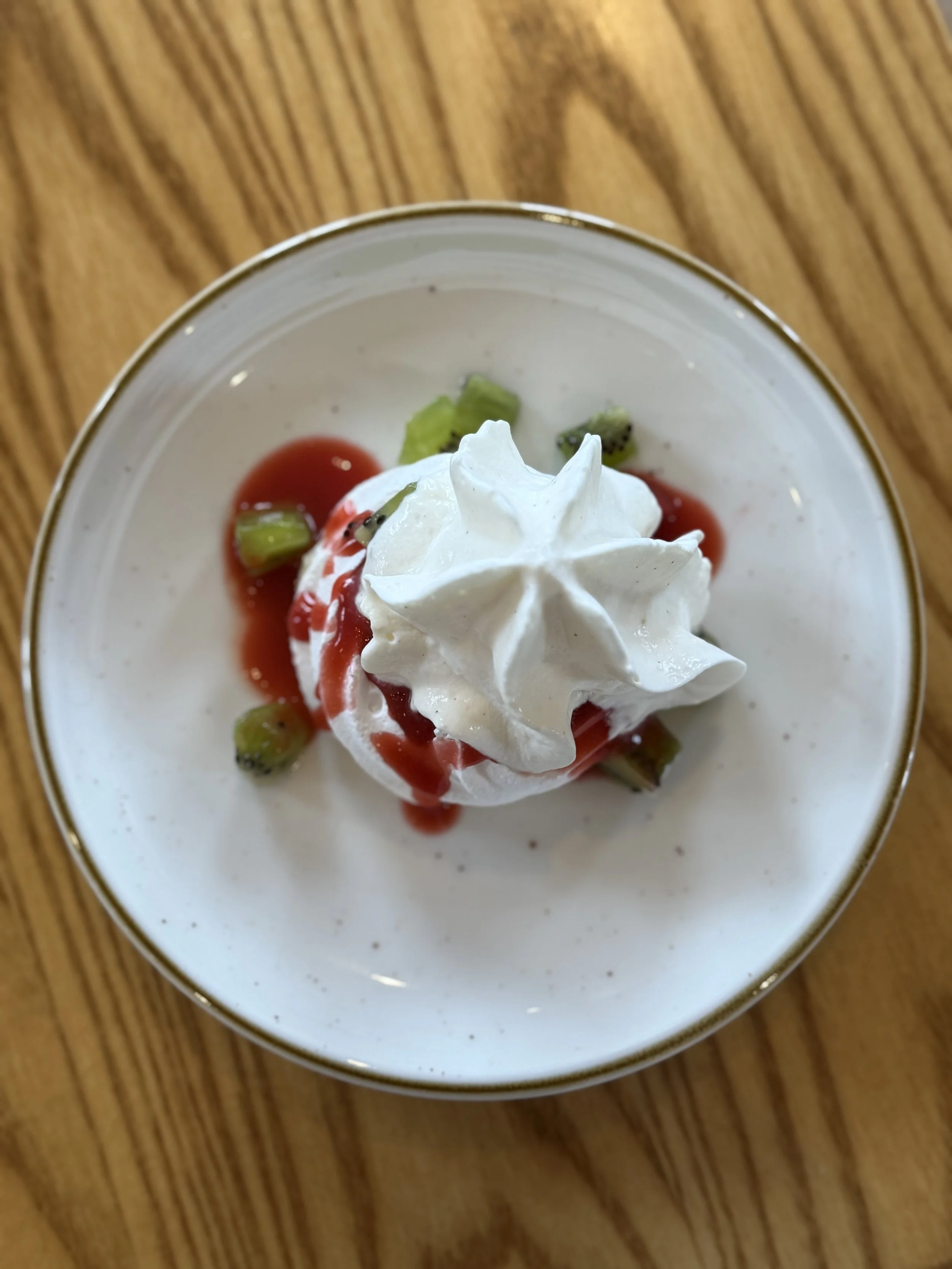 Pavlova with Kiwi and Strawberry and whipped cream