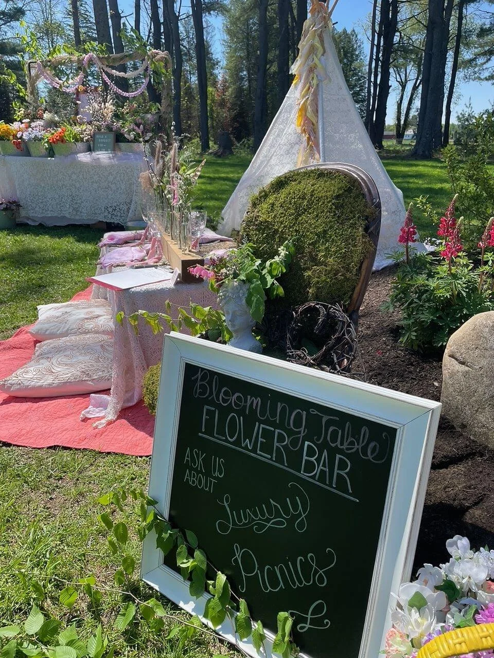 Moss chair, lace tent, and table of flowers