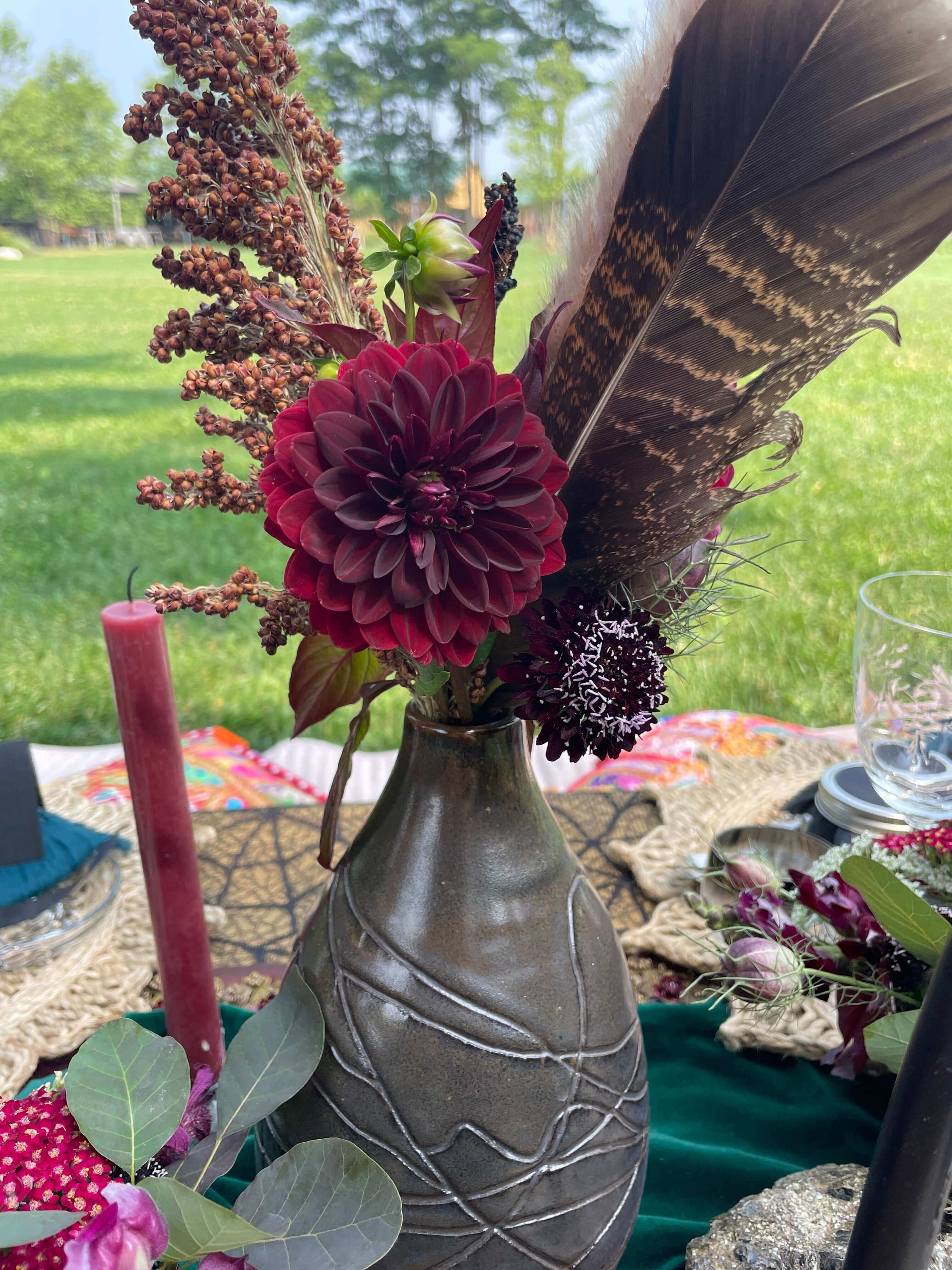 Dark bouquet with dahlia and feather