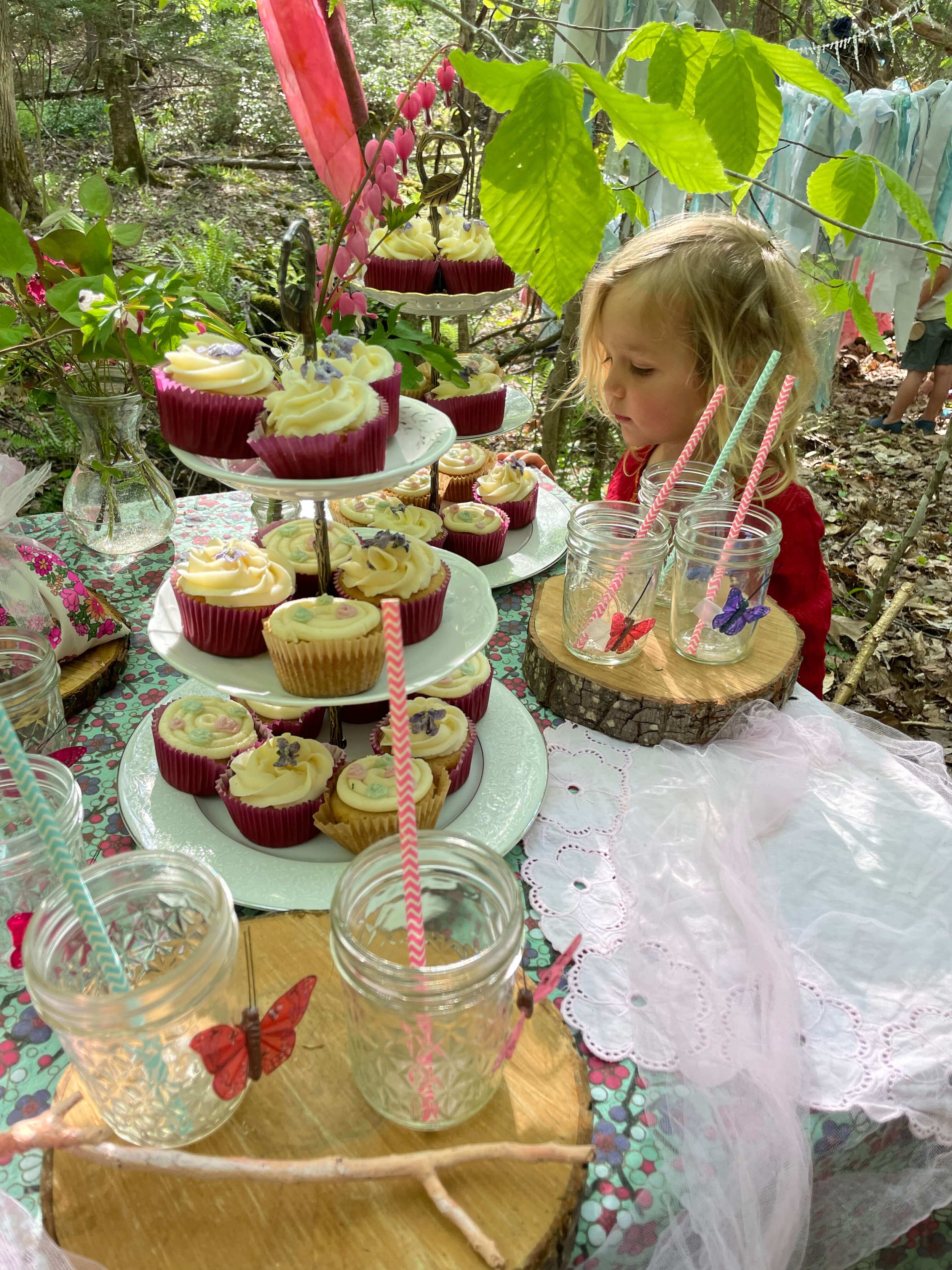 Child gazing at cupcakes