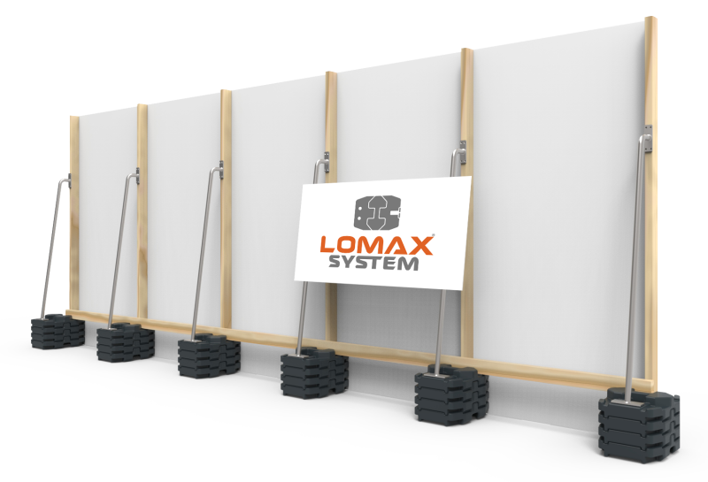 Display of wall framing with six set of foundations and a sign that reads 'LOMAX SYSTEM' with a logo.