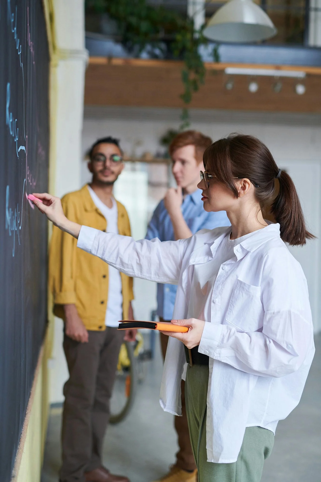 Woman writing on a board at a corporate workshop